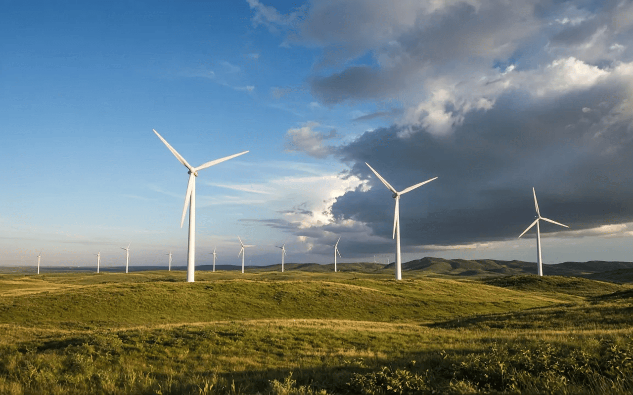 Wind turbines in a field as a storm builds